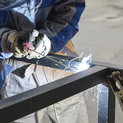 Man Welding A Bar